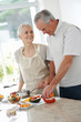 Elderly couple cooking food together Elderly couple cooking food together