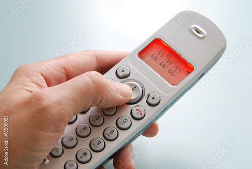 Photo: hand dialing the phone with shallow background hand dialing the phone with shallow background