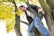 Young man ready to jump from a tree