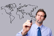 Businessman drawing the world map on a glass screen.