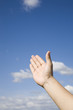 Hand reaching up to  the sky