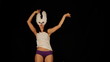 beautiful young masked woman dances to the groove