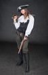 Young girl in costume of sea pirate with sabre and pistol