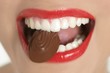 Chocolate sweet in beautiful woman mouth Chocolate sweet in beautiful woman mouth