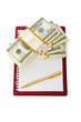 Stack of dollars and blank pad isolated