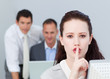 Portrait of a businesswoman asking for silence in the office