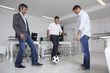 Young businessmen playing football