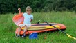 boy puts on a life jacket sitting on an inflatable rubber dinghy