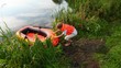 boy puts on a life jacket sitting down to inflatable rubber