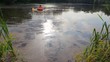 man with boy rowing on an inflatable boat away from coast