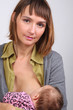 mother breast feeding her newborn baby in her arms