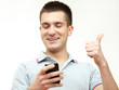 Foto: smiling young man with his mobile phone smiling young man with his mobile phone