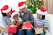 Happy Afro-American family opening Christmas presents