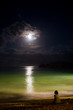 Solitude at night ocean with moon and moonlight reflection