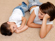 Beautiful and happy mother to the sleeping little boy