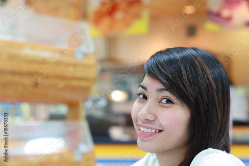 Photo: portrait of young asian lady in a restaurant portrait of young asian lady in a restaurant
