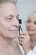 Senior medical practitioner examines man for hearing