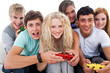 Portrait of teenagers playing video games in the living-room Portrait of teenagers playing video games in the living-room