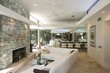 Photo: Sunken seating area and exposed stone fireplace of Palm Springs home interior Sunken seating area and exposed stone fireplace of Palm Springs home interior