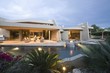 Palm Springs swimming pool and house exterior at dusk