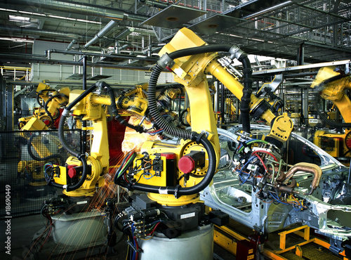 Photo: welding robots in a car manufactory welding robots in a car manufactory