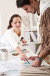Two interior designer working at office with color swatch