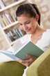 Students - Happy teenager with book sitting on armchair