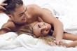 Beautiful young couple in the bedroom