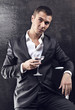 A young handsome businessman drinking a martini