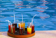 tray with many drinks on the poolside
