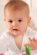Baby reaching for a peg