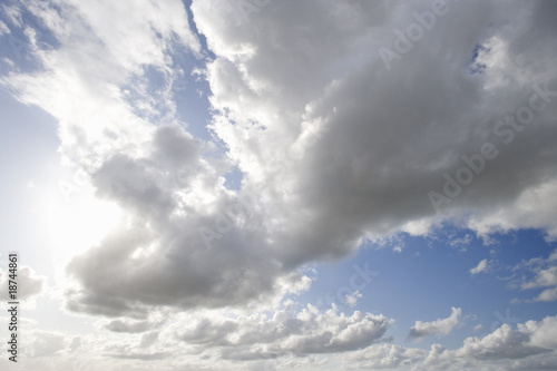 Photo: Sun shining in blue sky with clouds Sun shining in blue sky with clouds