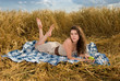 Beautiful slavonic girl on picnic in wheat field with apple