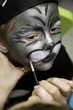 The boy makes a children's make-up The boy makes a children's make-up