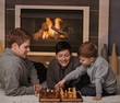 Young family playing chess