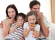 Happy family eating pizza