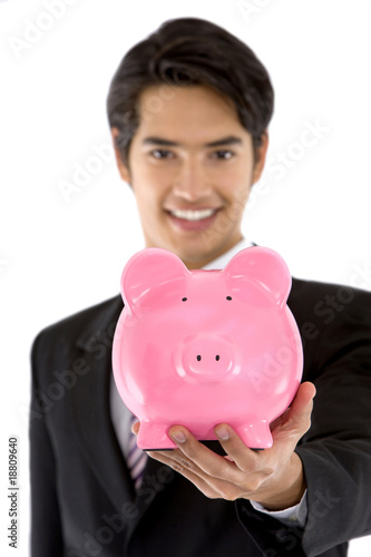 Photo: Business man with a piggybank Business man with a piggybank