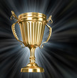 Gold cup on  black background with blue rays