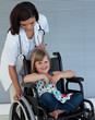 Female doctor pushing a wheelchair