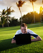 young man whith notebook on the green field
