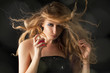 beautiful blond woman applying perfume on her body beautiful blond woman applying perfume on her body