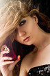 beautiful blond woman applying perfume on her body beautiful blond woman applying perfume on her body