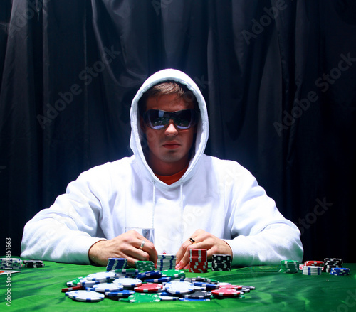 Photo: a poker player sitting at a table a poker player sitting at a table