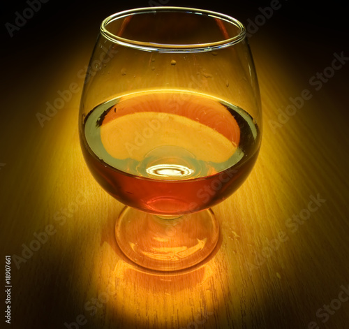 Photo: Glass of brandy with light on dark Glass of brandy with light on dark