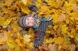 Boy in Autumn leaves