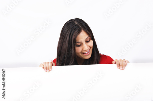 Photo: Woman holding sign isolated Woman holding sign isolated