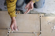 Closeup of a male hands working at a new floor tiles. Closeup of a male hands working at a new floor tiles.