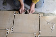 Closeup of hand of worker putting tiles on the floor. Closeup of hand of worker putting tiles on the floor.