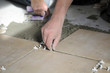 Closeup of hand of worker putting tiles on the floor. Closeup of hand of worker putting tiles on the floor.