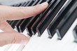 hand playing music on the piano
